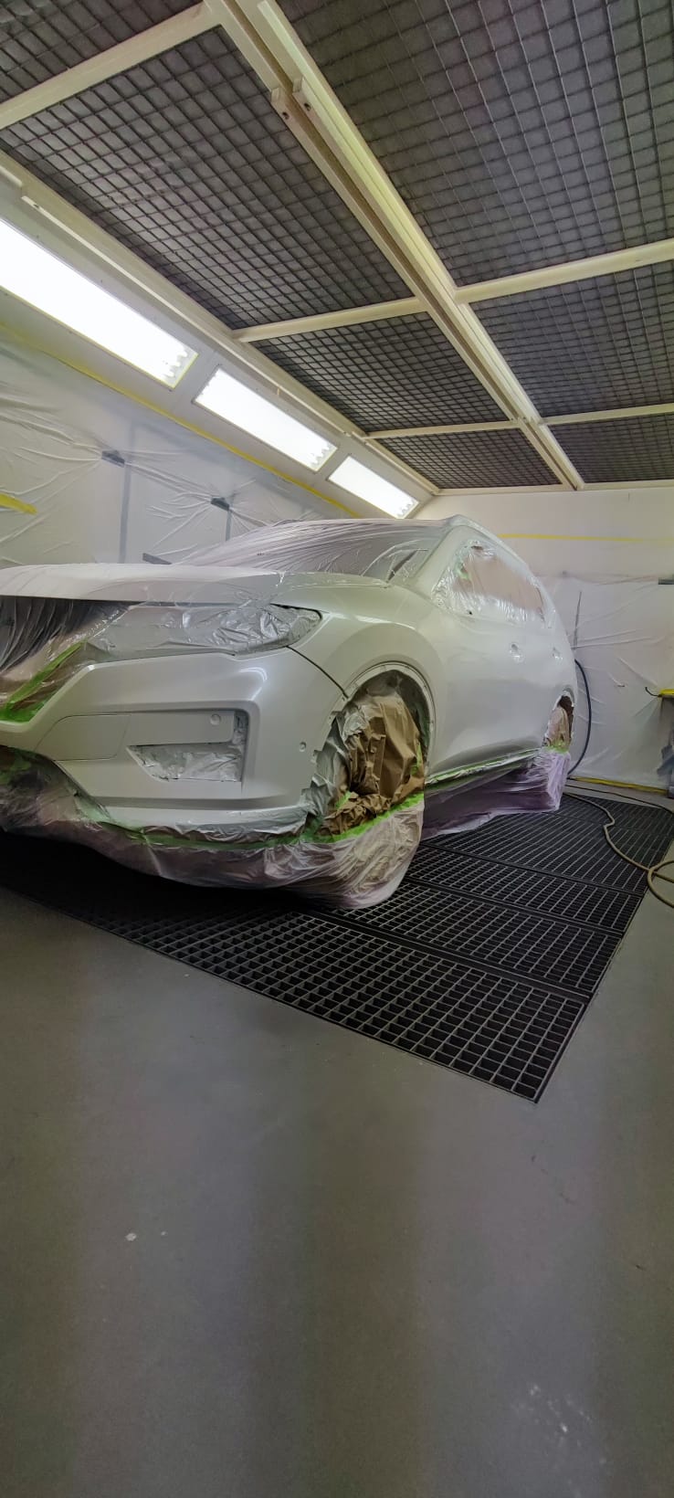 Weißer Nissan X-Trail abgeklebt in der Lackierkabine vor der Leasing-Rückgabe — BodyTech Karosserie